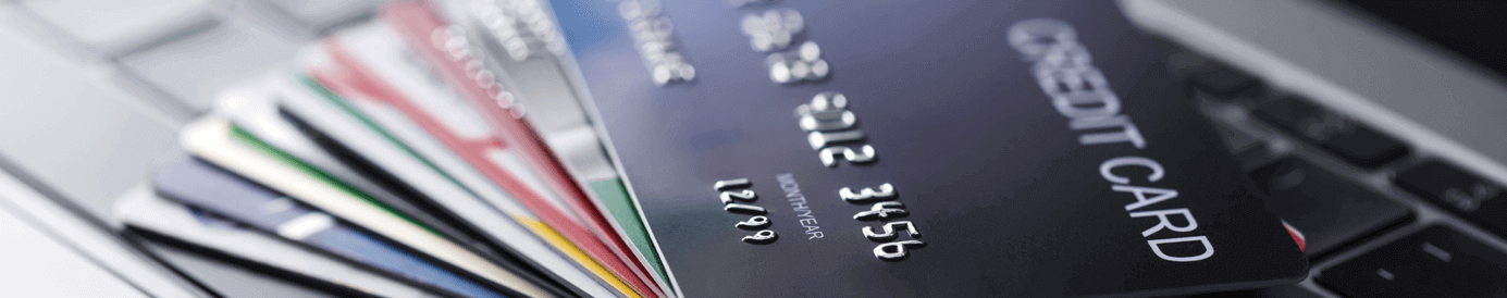 Credit cards spread across a laptop keyboard