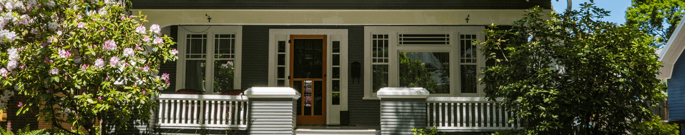 A person in a blue button down is holding their phone in one hand and their credit card in the other.