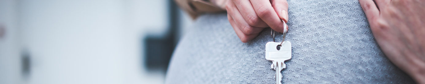A couple hugging after buying their first home