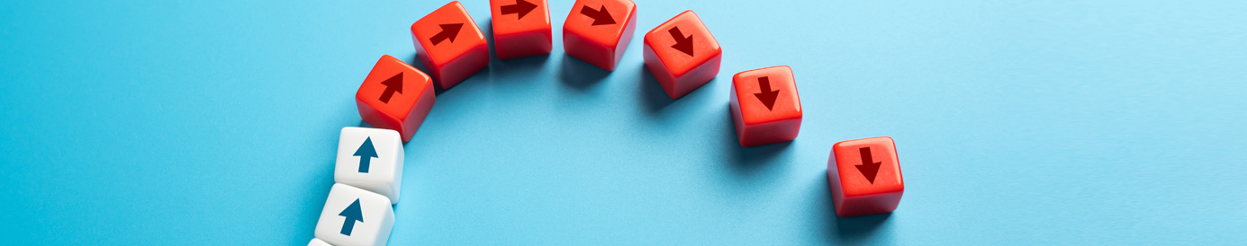Dice-like cubes with arrows on the sides are lined up in a row that arcs up then down, turning white to red as they arc down.
