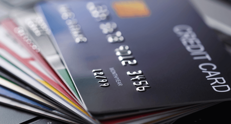 Credit cards spread across a laptop keyboard