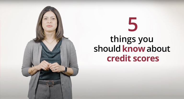 A woman dressed in business-casual clothing standing next to the text 