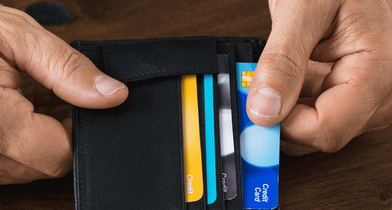 Hand removing credit card from wallet